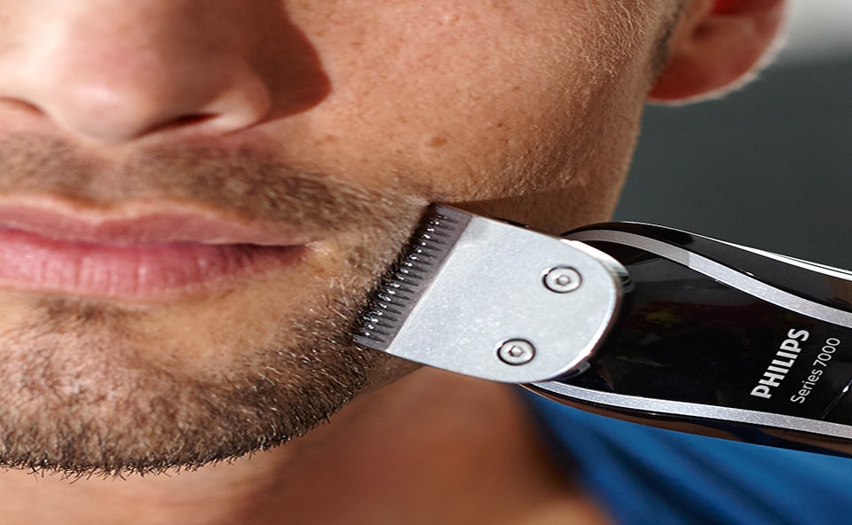 man shaving his beard