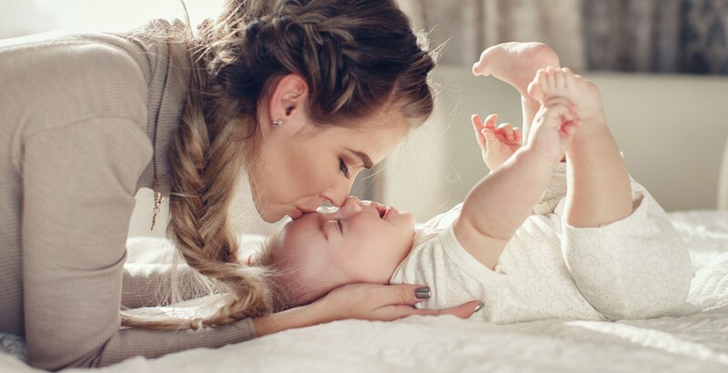 mother kissing baby