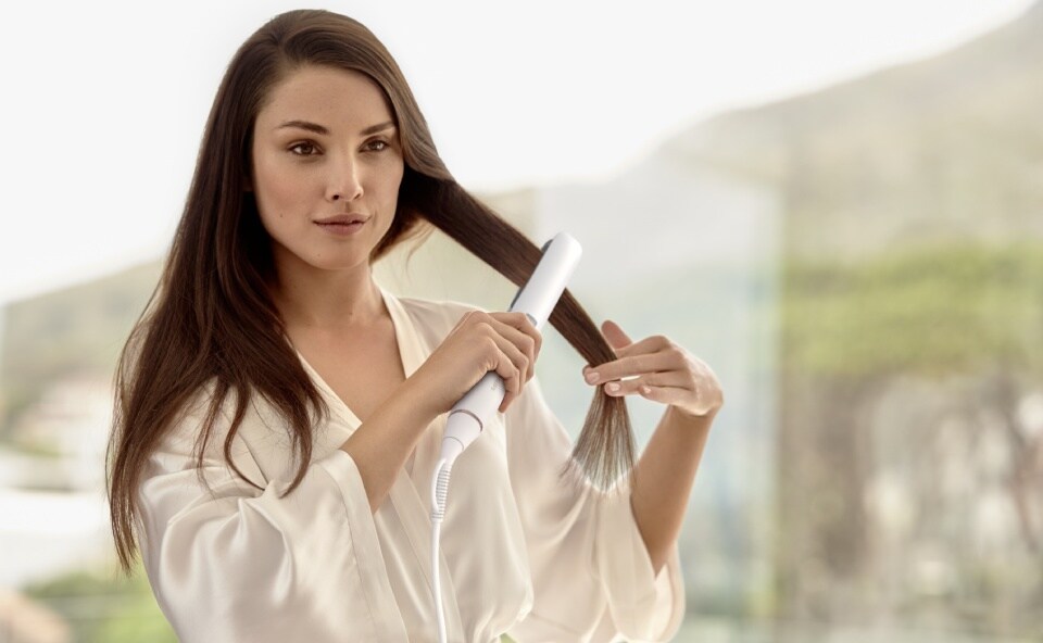 women straightening her hair
